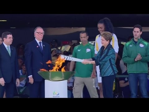 Protestor attempts to grab Olympic torch at Rio 2016 relay