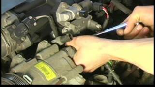 How to Replace an Air Conditioning Compressor in a Ford Explorer : Removing Manifold From Air Conditioning Compressor in a Ford Explorer