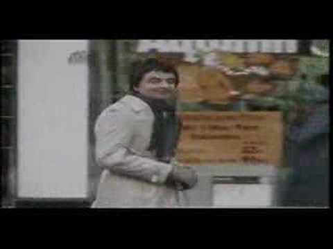 Rowan Atkinson walking in Not The Nine O'Clock News