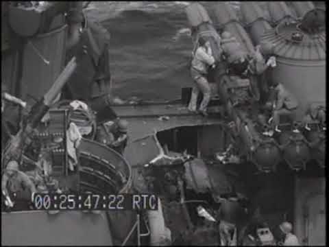 USS Braine DD-630 transferring wounded to USS New Mexico after hit by a Japanese 6" shell; Tinian