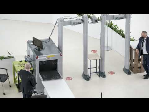 Security check of conference participants with x-ray luggage scanning, top view time lapse