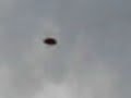 Oval Shaped  Shining UFO in Sky