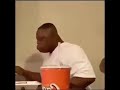 Black man falls off chair