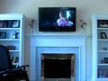 Plasma TV mounted over fireplace. 