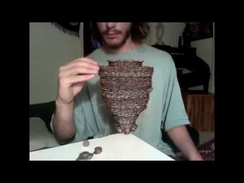 Watch A Guy Magically Balance 3000 Coins On Top Of A Dime