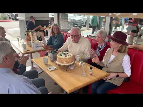 George Connelly blowing out candles on his birthday cake - November 2021