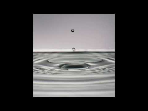 Single drop falling into the water