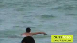 Jason Kennedy and Adam Gregory play in the beach at the Eden Roc Hotel