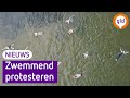 Ludiek protest in Wageningen: zwemmen tegen smeerpijp