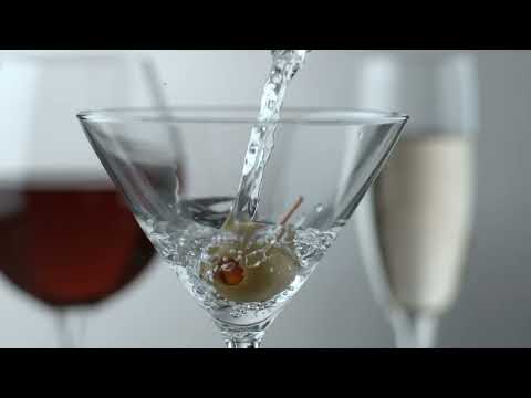 LIQUID BEING POURED OVER AN OLIVE IN A MARTINI GLASS EXTREME SLOW MOTION 4K