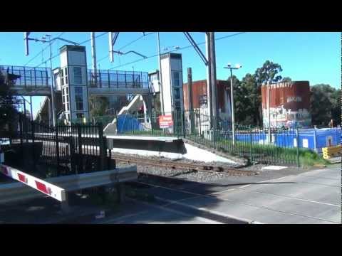 PACIFIC NATIONAL'S NR16/35/AN1 FLYING PAST CASULA STATION/LEVEL CROSSING