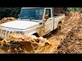 Mahindra bolero 4x4 pickup offroad escaping through mud road