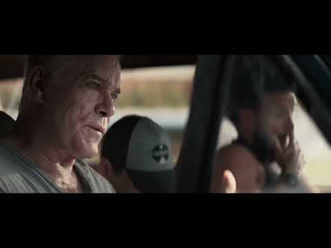 Trailer image of riot glow over Los Angeles skyline, symbolizing the score’s tense pulse under the songs