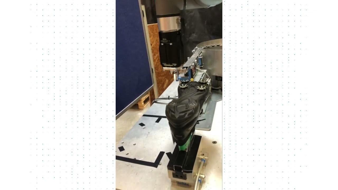 A vision-guided robot assembling spikes on shoes