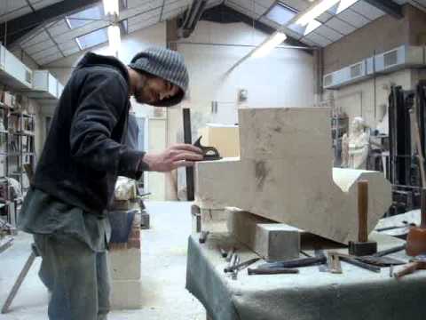 Stonemason using axe