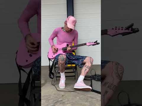 MGK playing his pink guitar 👽