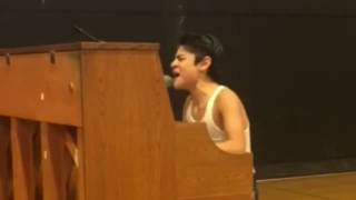 Kid performs Bohemian Rhapsody in front of whole s