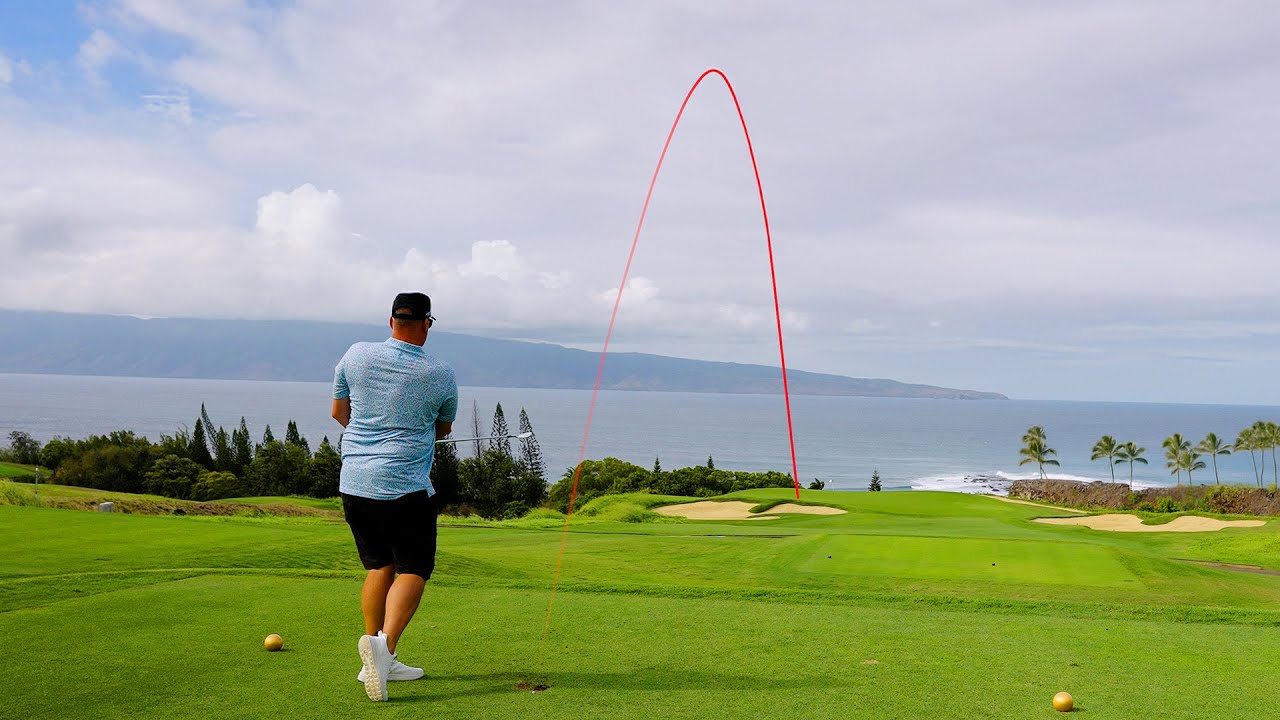 A golfer on a beautiful Kapalua golf course with the ocean in the background