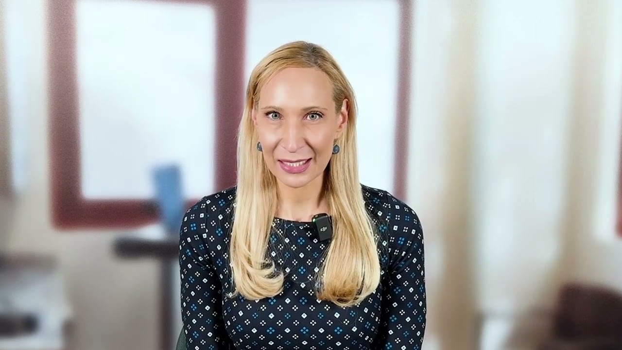 Dr. Sonia Reichert, MD, Hematologist and Oncologist, sitting in front of a blurred window