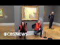 Climate activists throw mashed potatoes on a Monet painting to protest fossil fuel extraction