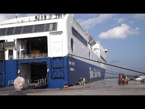 BlueStar Ferry docking in Port Rhodos in stormy weather with rope demolition