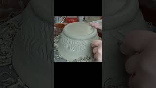 Carving a pottery bowl