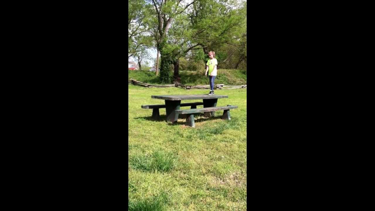 Kid does a cartwheels off picnic table