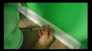 Caulking behind a toilet (portable caulk gun)