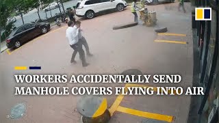 Chinese workers accidentally send manhole covers flying into air