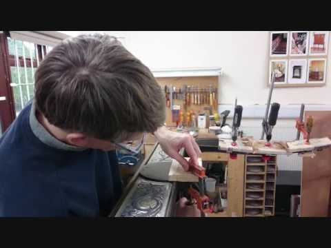 The restoration of an ebony table with gilt mounts and brass inaly