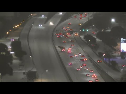 Cars pile up along the icy roads of Woodall Rodgers Freeway