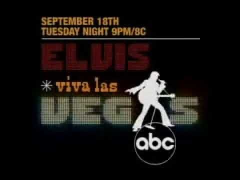 Promo frame: close-up on Elvis at the International, baton-hand cue to the rhythm section