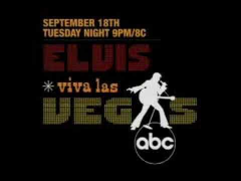 Promo frame: brass section hits under follow-spot as Elvis cues the band