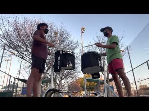 two brown boys play pulse 22 snare break