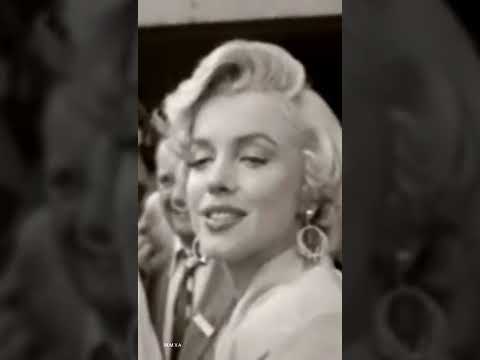Marilyn Monroe puckering up a kiss for her fans in Sept 1954. arriving at Idlewild airport NY.