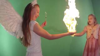 Angels are holding fire in 4K. Children with angels. Two angels.