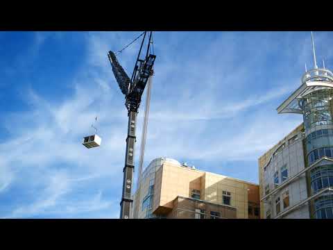 (Drone)HUGE Crane lifts equipment on top of Rainbow...