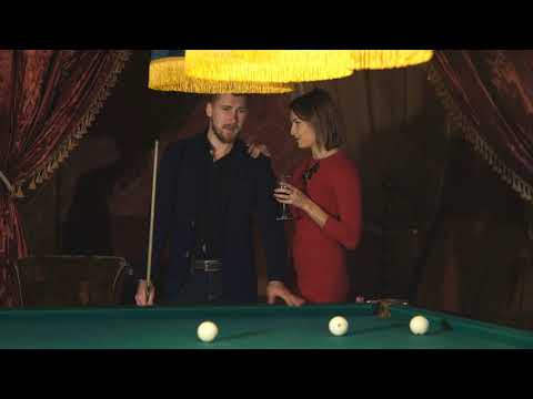 beautiful happy couple playing billiards