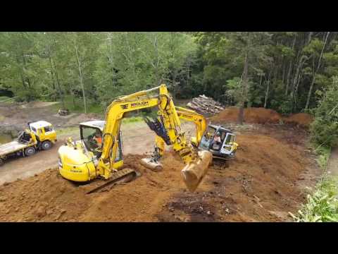 Two diggers working together making terraces!
