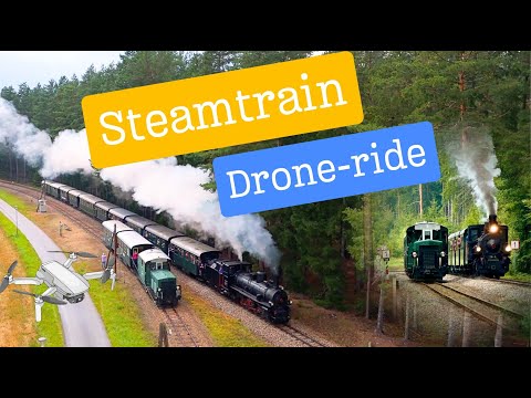 Parallel exit of a steamtrain and vintage diesel locomotive | Cinematic Drone 4k Video
