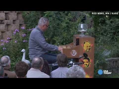 See why man is bicycling a piano along the Miss. River