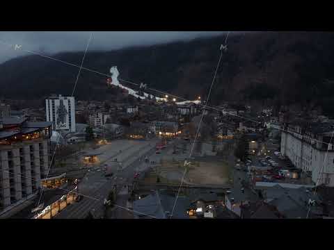 Dusk settles over Chamonix town center nestled in the French Alps, lights illuminating the streets
