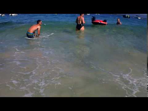 A boy is going in the waves in Corsica