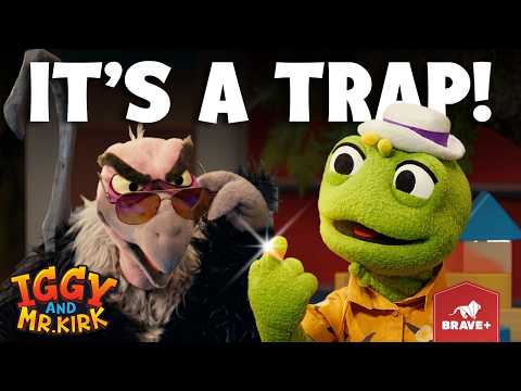 Two puppets from a kids' show in a dramatic scene: a green frog in a hat and orange shirt, and a feathery villain wearing sunglasses, with the text 'It's a trap!'