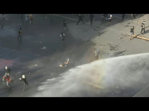 Police hit protesters in Santiago, Chile with water cannons | AFP