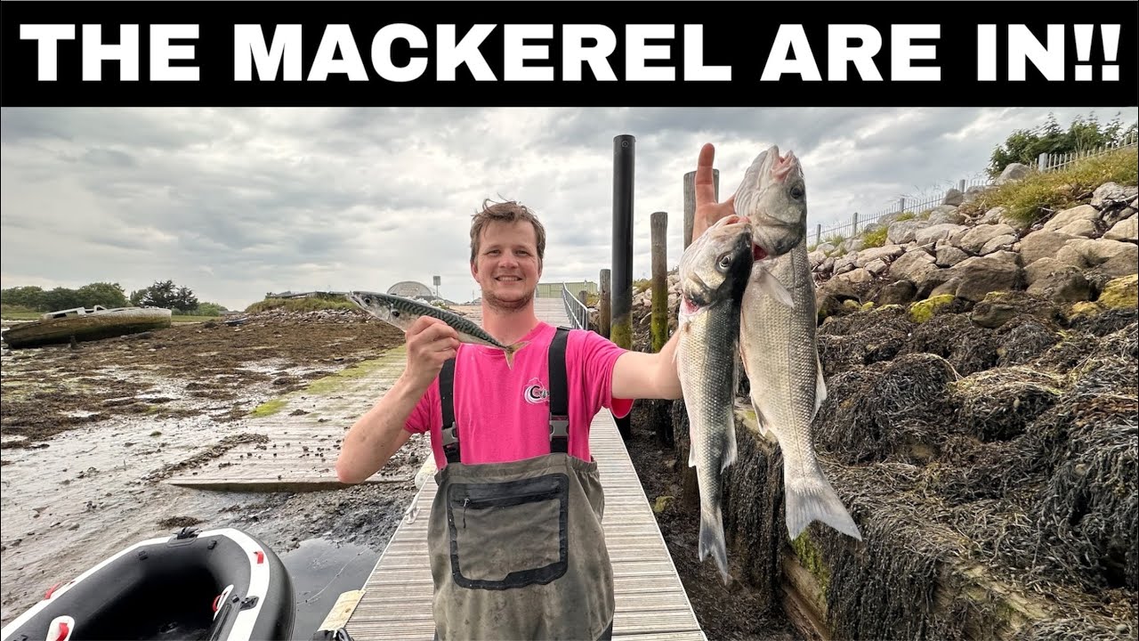 Man stands next to his inflatable boat holding up the mackerel and bass that he caught