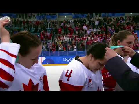 Canada’s Jocelyne Larocque takes off silver medal moments after receiving it.