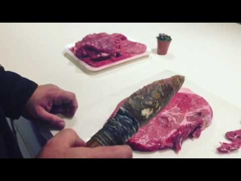 Testing the sharpness of a flint stone hunting knife