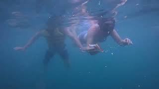 Two friends from Australia went swimming in the sea on a rainy day.