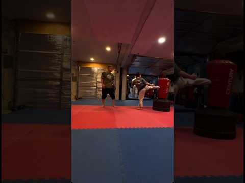 Jason Arena Jr working on some sidekick combinations in taekwondo class with Master Bobby Leach.